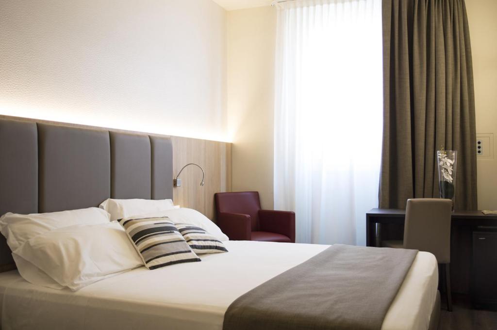 Postel nebo postele na pokoji v ubytování Hotel Alexander