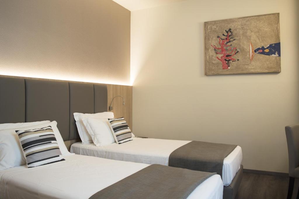 Postel nebo postele na pokoji v ubytování Hotel Alexander