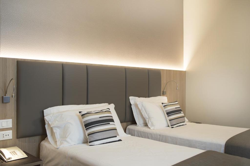 Postel nebo postele na pokoji v ubytování Hotel Alexander
