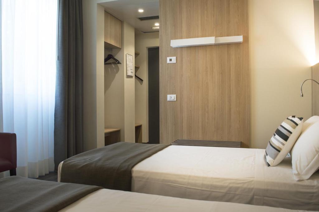 Postel nebo postele na pokoji v ubytování Hotel Alexander