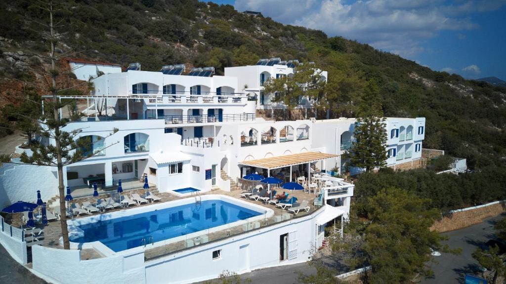 an aerial view of a large white building with a swimming pool at Karma Minoan in Agios Nikolaos