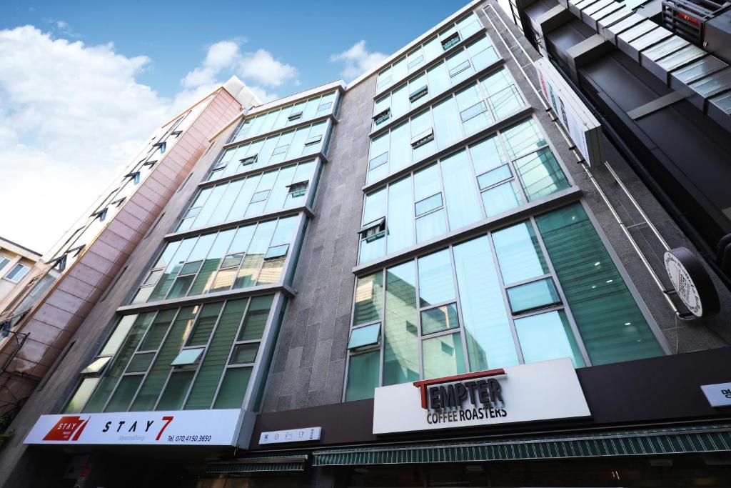 a building with glass windows on the side of it at STAY7 Myeongdong in Seoul