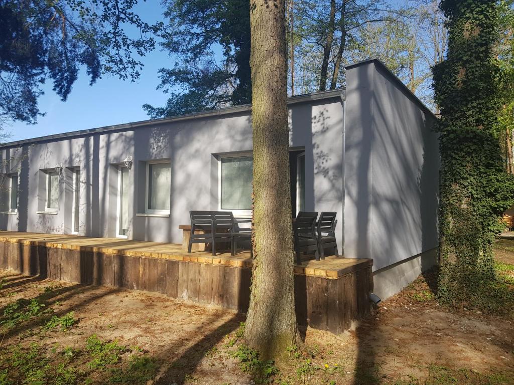 a modular house with a table and chairs next to a tree at Wiking in Turawa