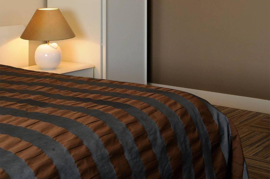 Postel nebo postele na pokoji v ubytování Hotel Salons De Vrede
