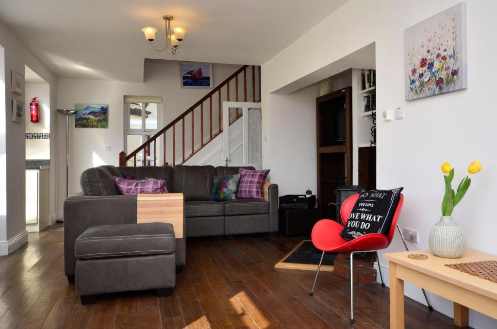 a living room with a couch and a chair at Cottage 139 - Clifden in Clifden