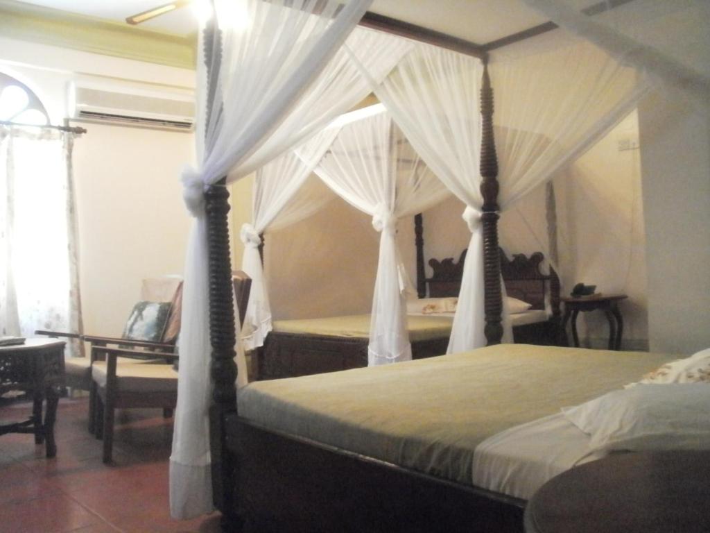 Postel nebo postele na pokoji v ubytování Asmini Palace Hotel