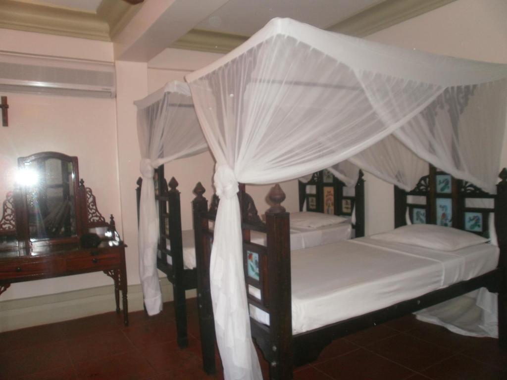 Postel nebo postele na pokoji v ubytování Asmini Palace Hotel