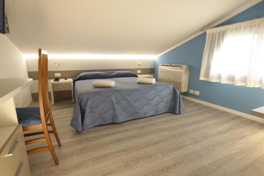 Postel nebo postele na pokoji v ubytování Hotel Serenella