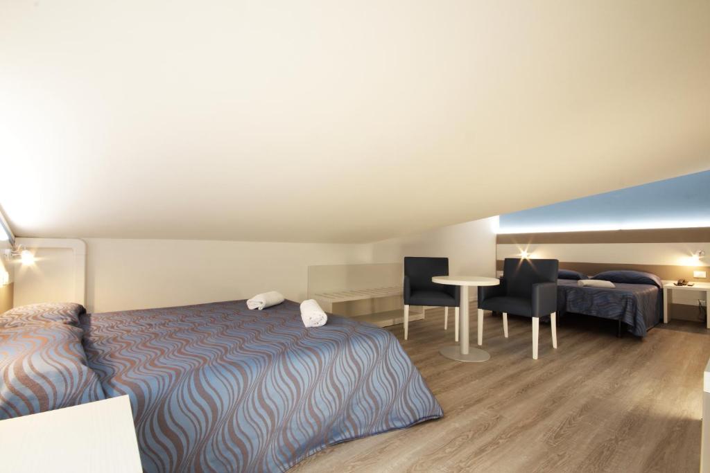 Postel nebo postele na pokoji v ubytování Hotel Serenella