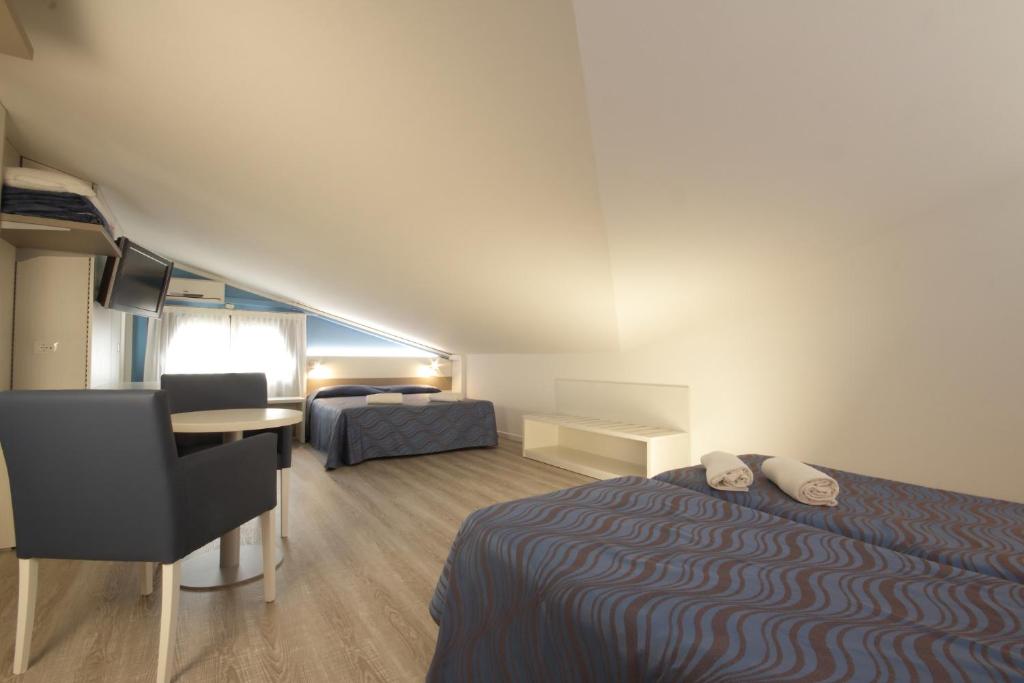 Postel nebo postele na pokoji v ubytování Hotel Serenella