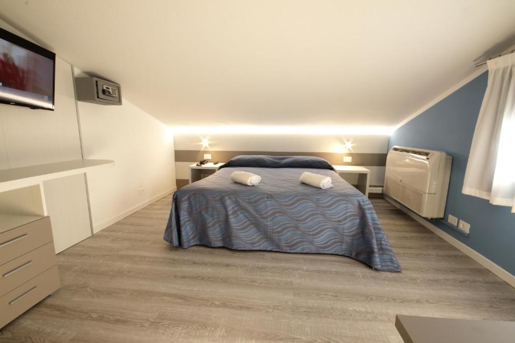 Postel nebo postele na pokoji v ubytování Hotel Serenella