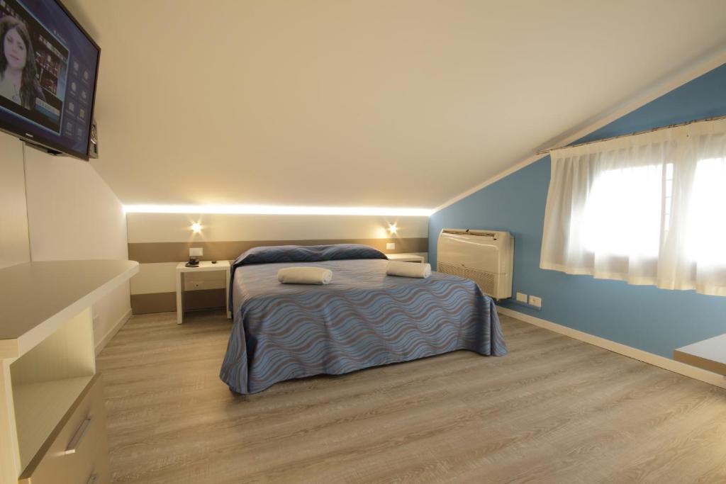 Postel nebo postele na pokoji v ubytování Hotel Serenella