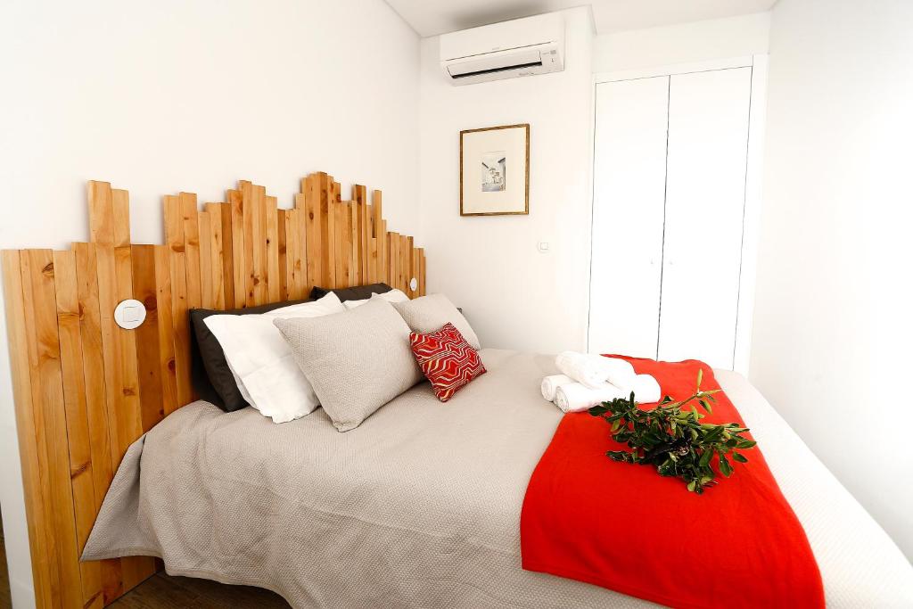- une chambre avec un lit doté d'oreillers rouges et blancs dans l'établissement NEW Lisbon downtown Houses-4A, à Lisbonne