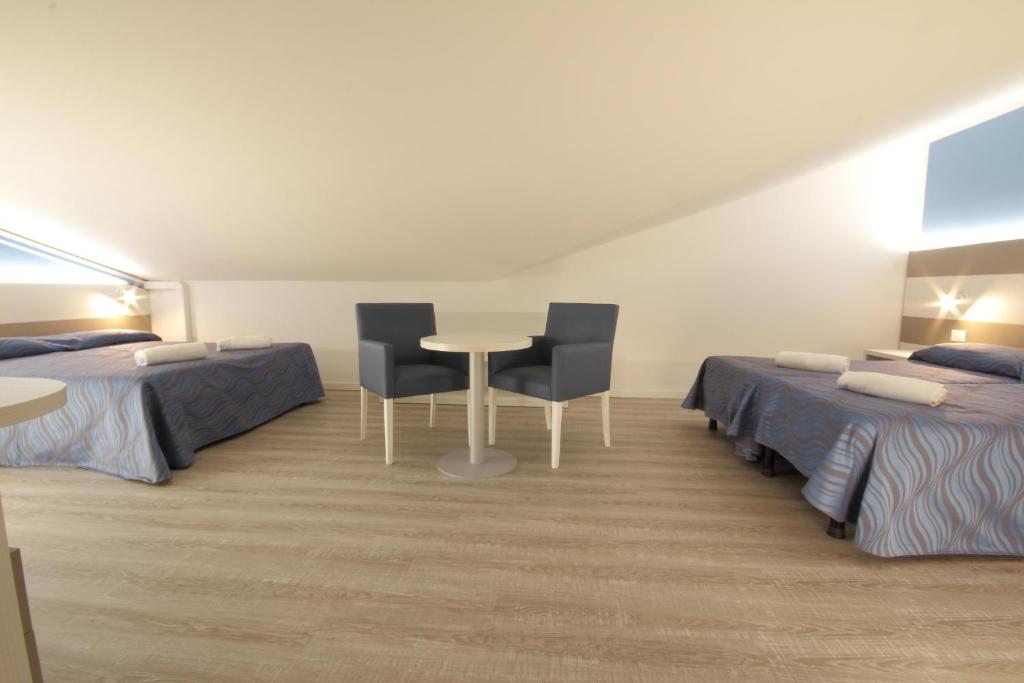 Postel nebo postele na pokoji v ubytování Hotel Serenella