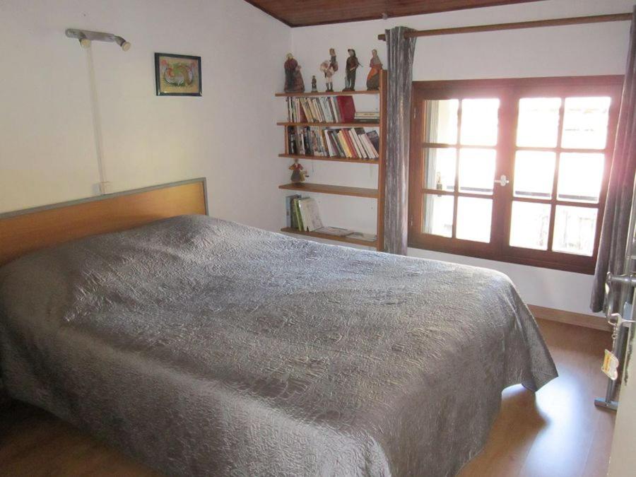 Un dormitorio con una cama grande y una ventana en la cle des champs, en Saou