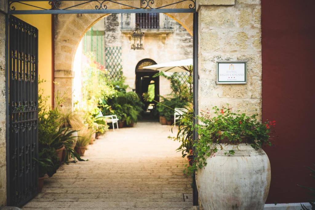 un ingresso a un edificio con arco e piante di Hotel Baglio Catalano a Custonaci
