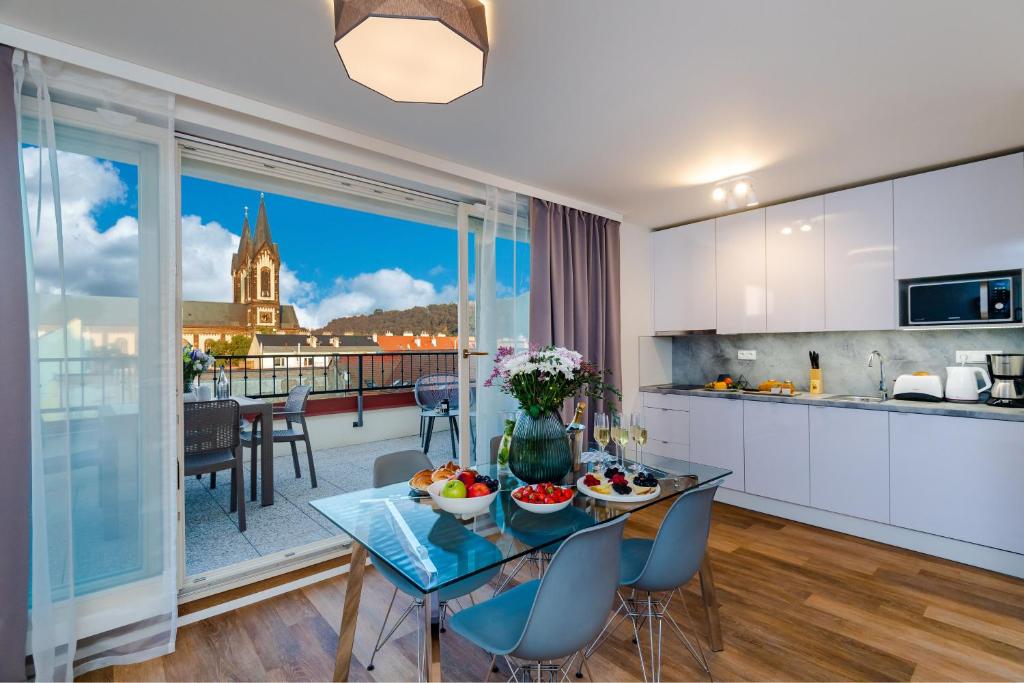 a kitchen and living room with a table with fruit on it at Seven Wishes Boutique Residence in Prague