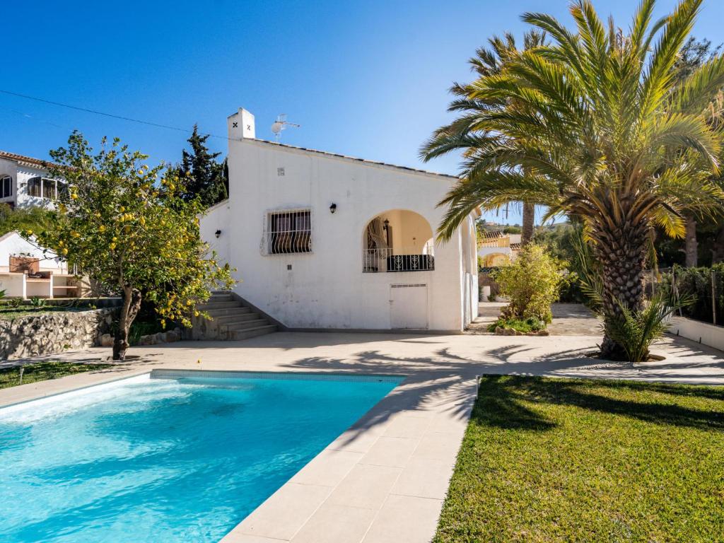 a villa with a swimming pool in front of a house at Villa Aurelie by Interhome in Balcon del Mar