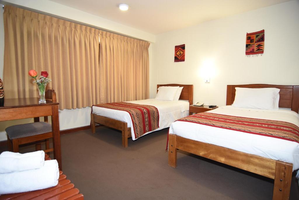 Postel nebo postele na pokoji v ubytování Hotel Prisma Cusco