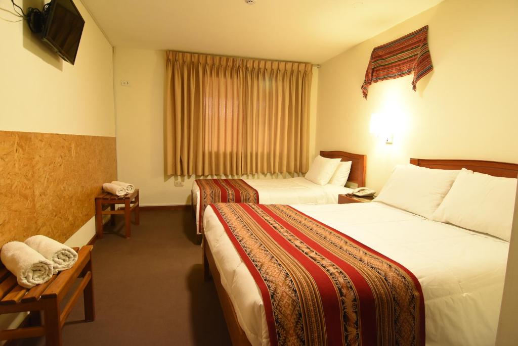 Postel nebo postele na pokoji v ubytování Hotel Prisma Cusco