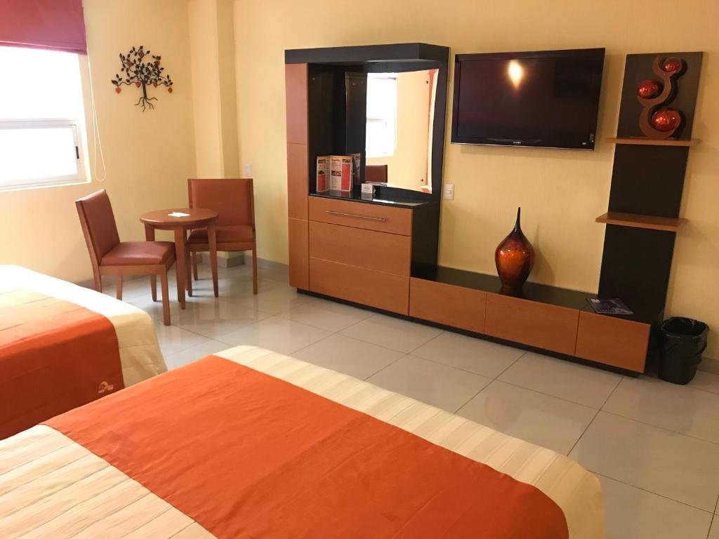 Postel nebo postele na pokoji v ubytování Hostalia Hotel Expo & Business Class