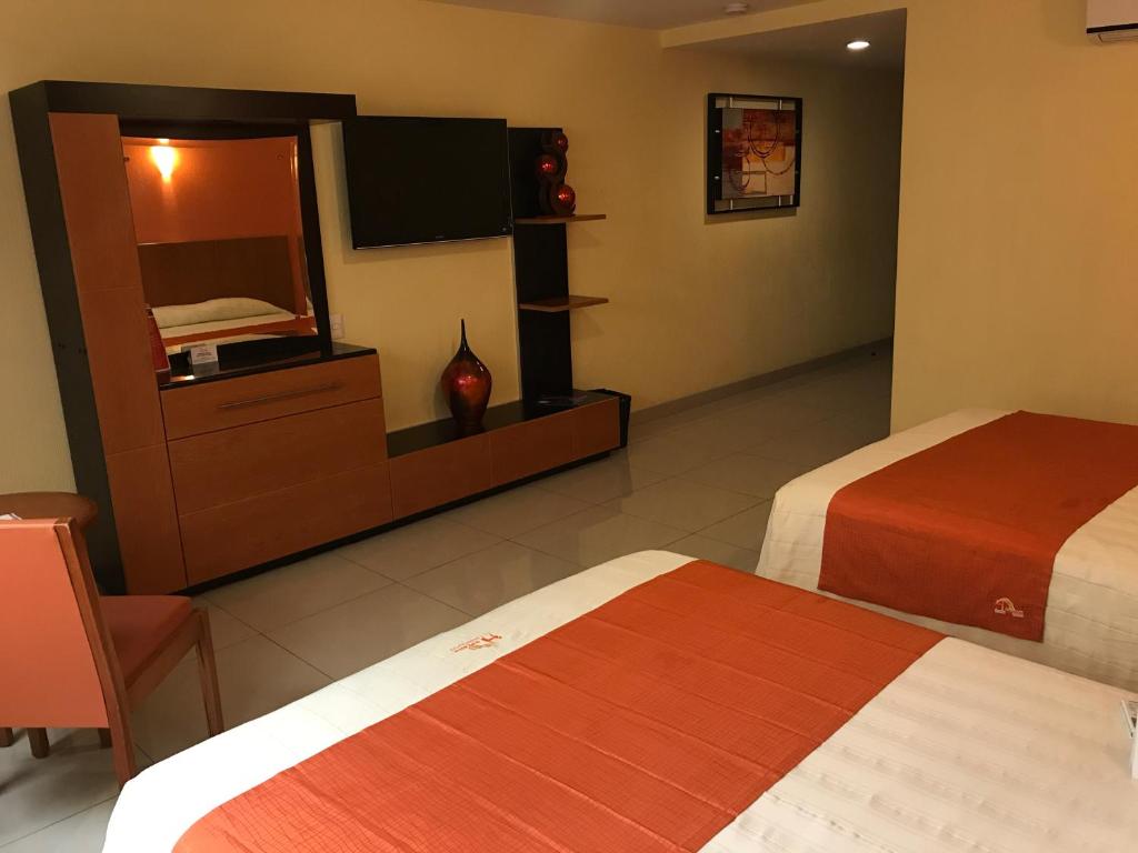 Postel nebo postele na pokoji v ubytování Hostalia Hotel Expo & Business Class