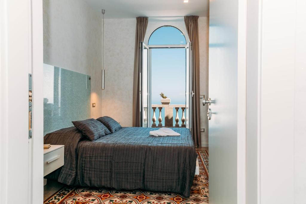 a bedroom with a bed and a large window at B&B Villa Belvedere in Vasto