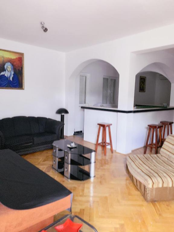 a living room with a couch and a table at Hostel Holiday Cetinje in Cetinje