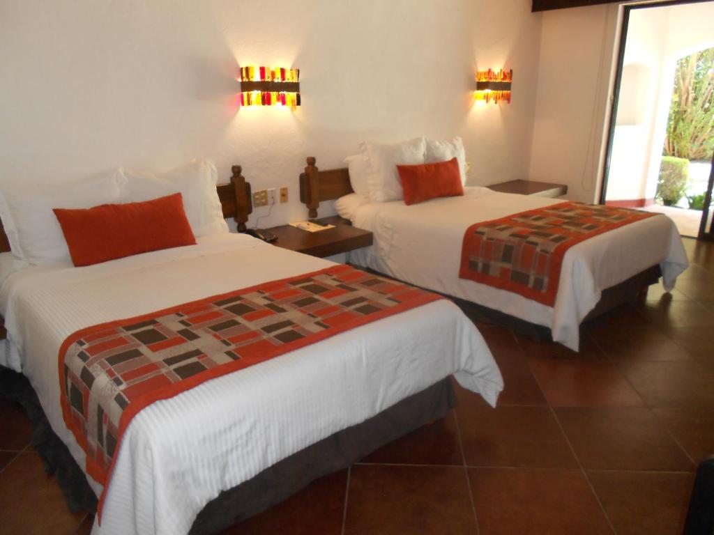 Postel nebo postele na pokoji v ubytování Hotel Hacienda Taboada (Aguas Termales)