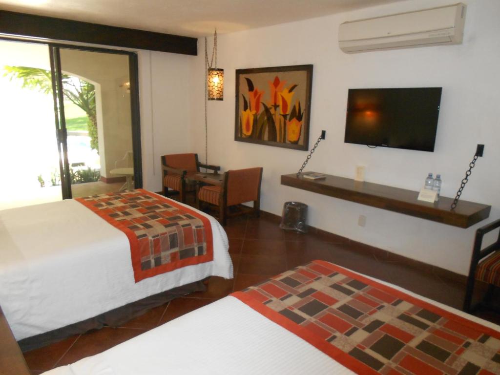 Postel nebo postele na pokoji v ubytování Hotel Hacienda Taboada (Aguas Termales)