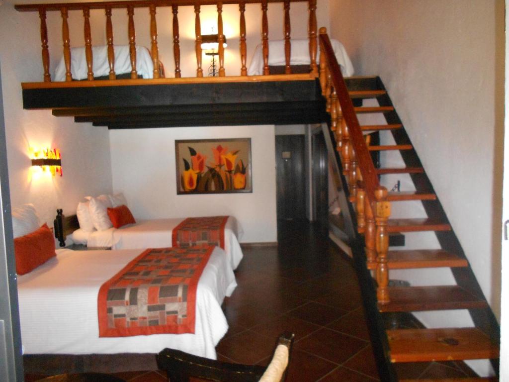 Postel nebo postele na pokoji v ubytování Hotel Hacienda Taboada (Aguas Termales)