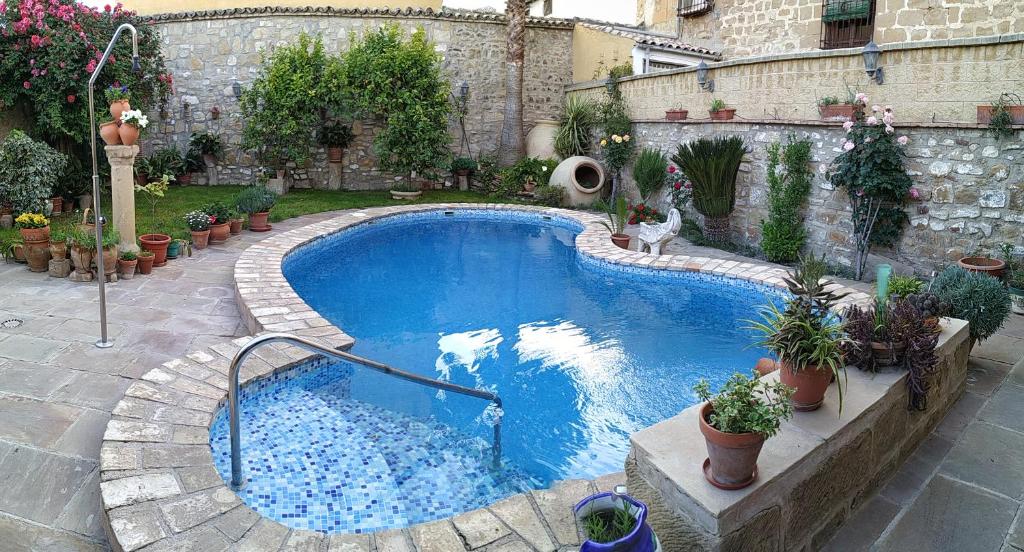 una piscina en un patio con macetas en VTAR Casa las Tinajas, en Baeza