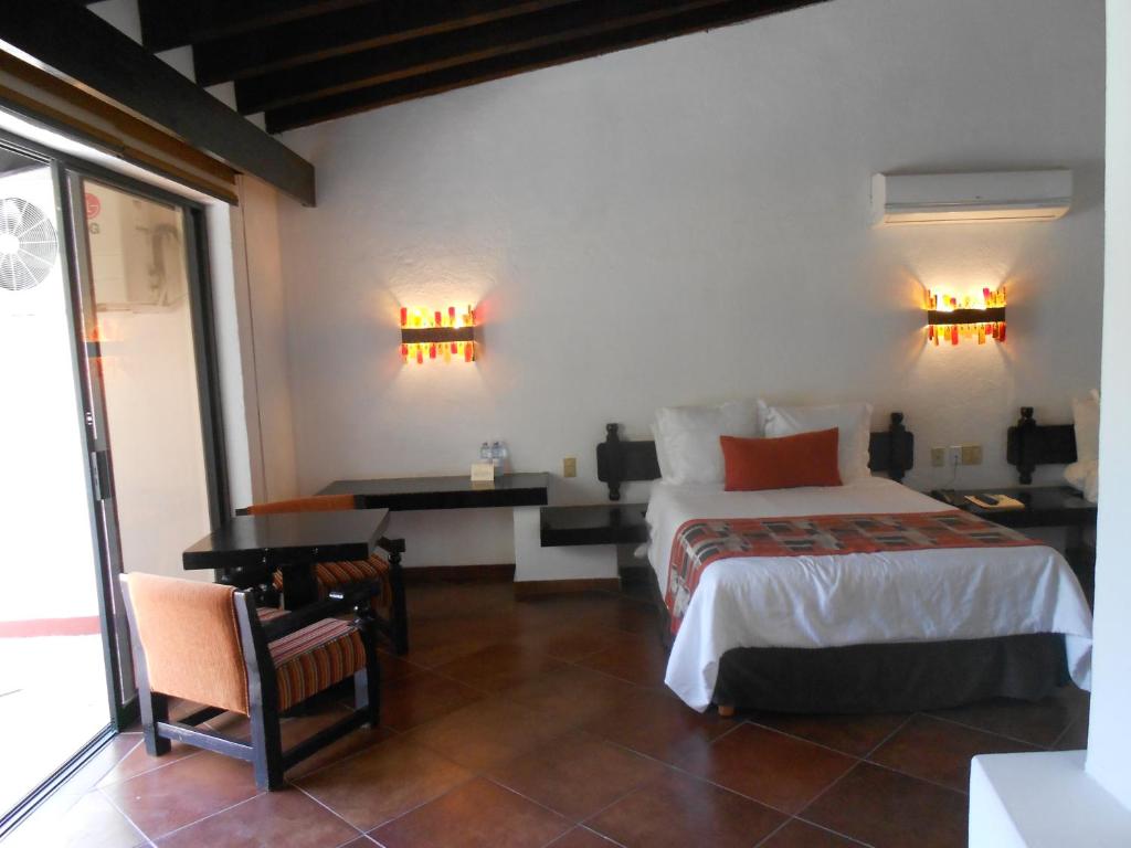 Postel nebo postele na pokoji v ubytování Hotel Hacienda Taboada (Aguas Termales)