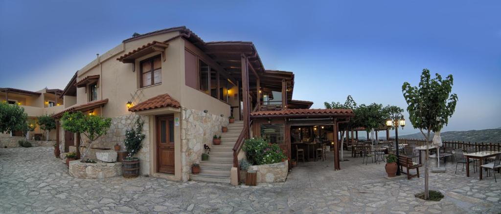 a building with a restaurant in front of it at Earino in Kato Asites