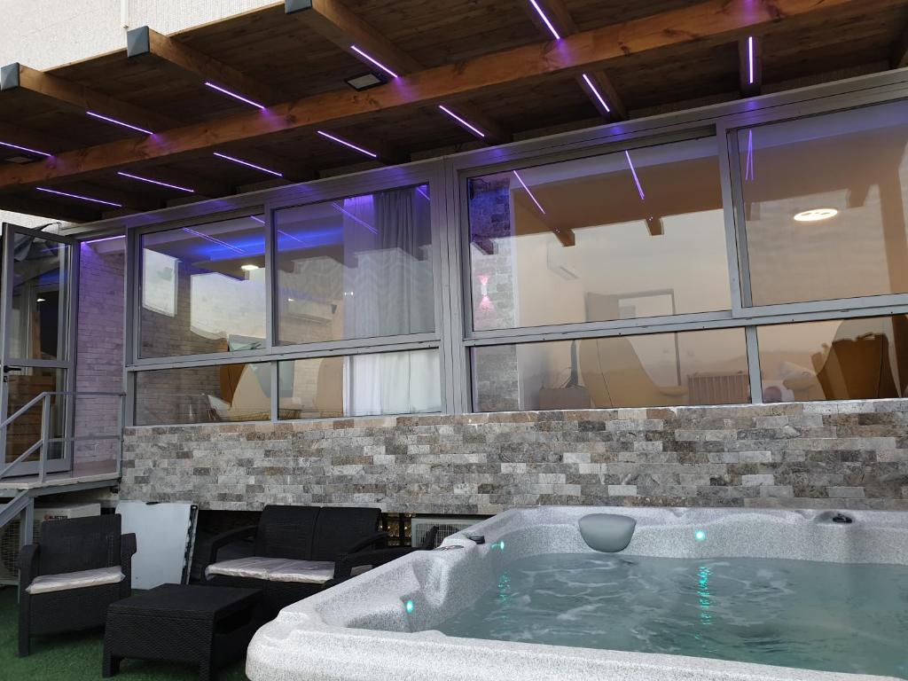 a large bath tub in a room with windows at Avshalom Holiday Apartments in Eilat