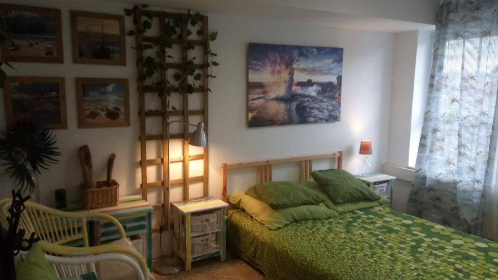 a bedroom with a bed with a green comforter at Friedens apartment in Plauen