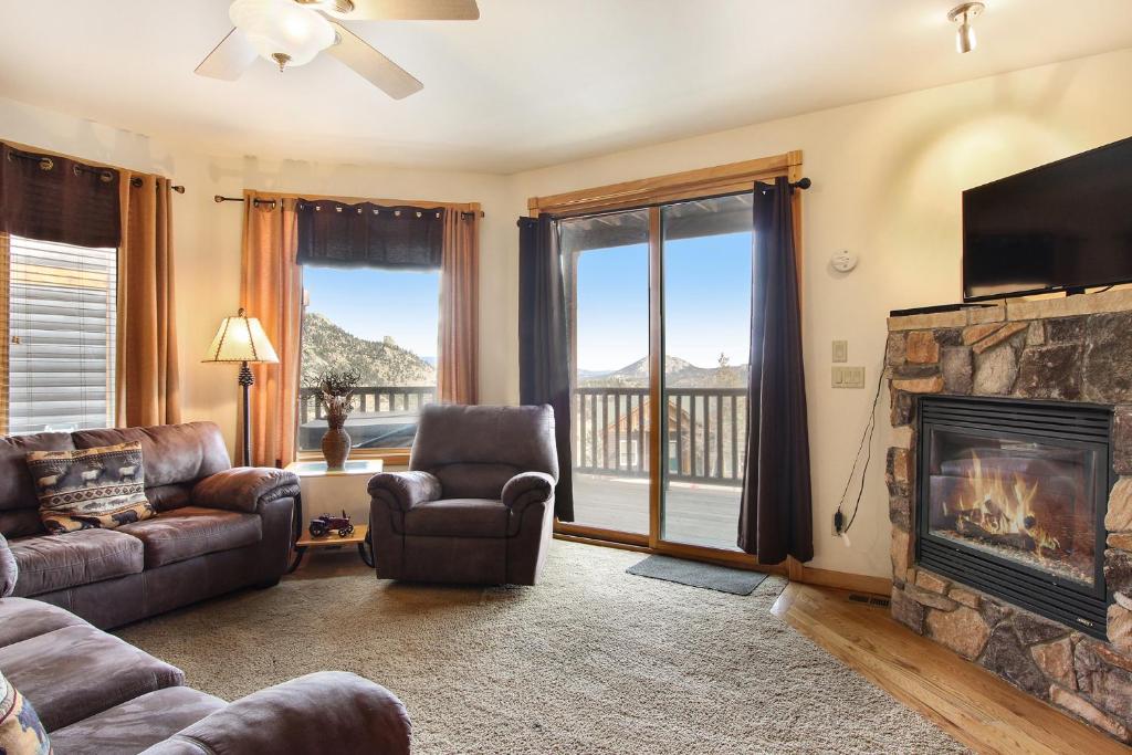 a living room with a couch and a fireplace at Chiefs Head Peak 21B Condo in Estes Park