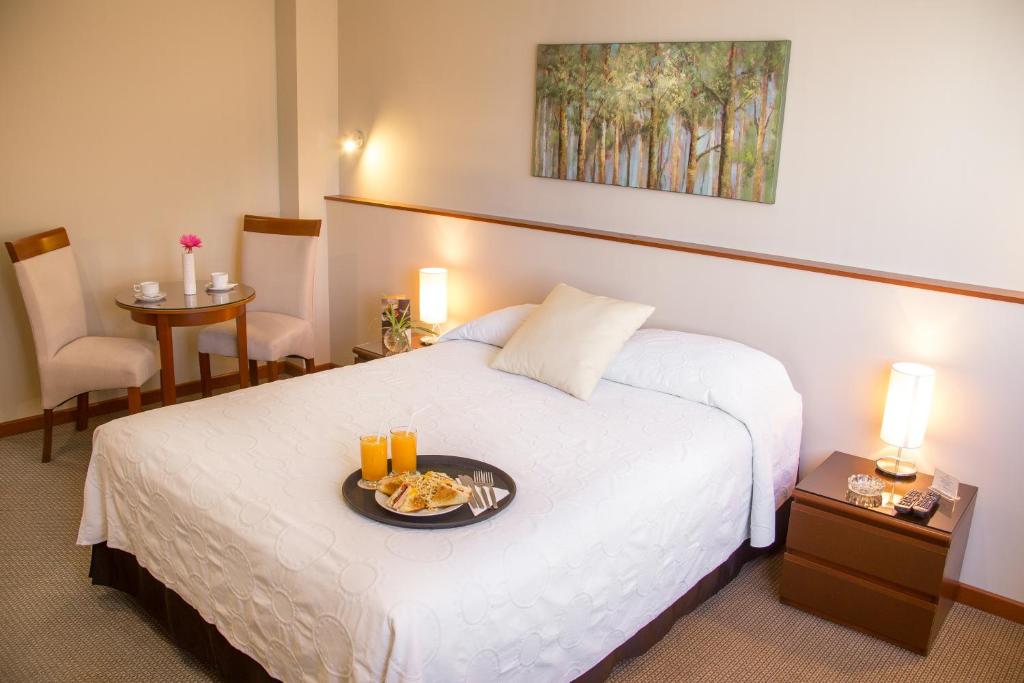 Postel nebo postele na pokoji v ubytování Hotel Park Suites