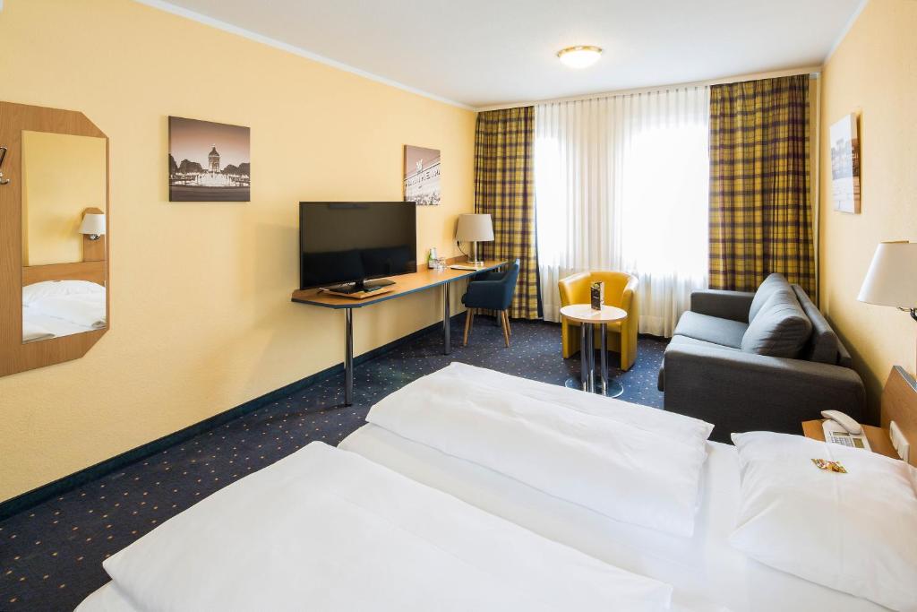 a hotel room with a bed and a desk at Central Hotel in Mannheim