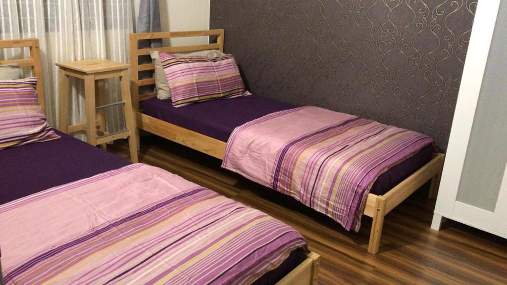 Postel nebo postele na pokoji v ubytování Bayu TAMARA RESIDENCE PUTRAJAYA