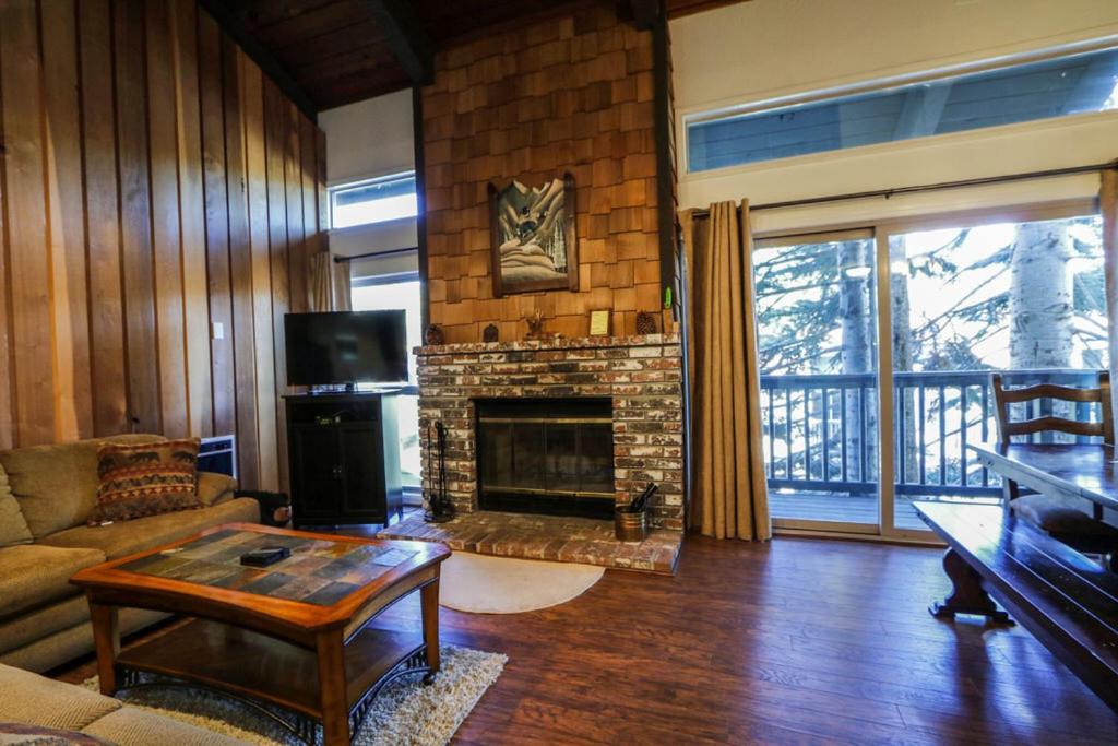 a living room with a fireplace and a couch at Chamonix Condo 94 Condo in Mammoth Lakes