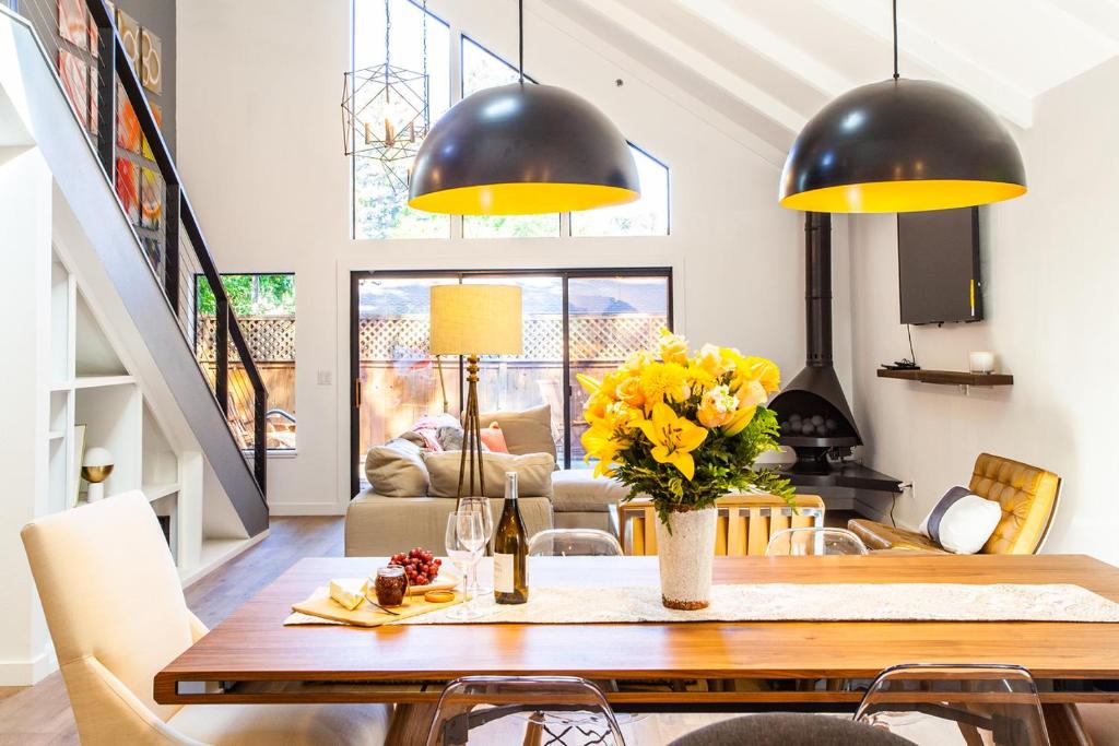 a dining room with a table with yellow flowers at 758 Broadway House in Sonoma