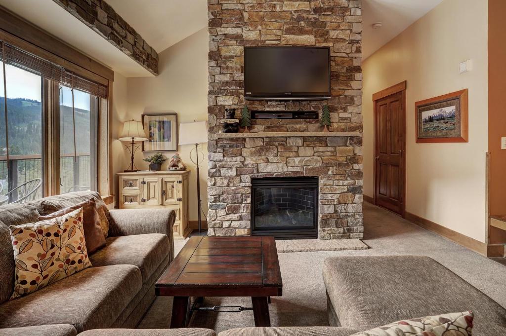 a living room with a couch and a fireplace at 8912 The Springs Condo in Keystone