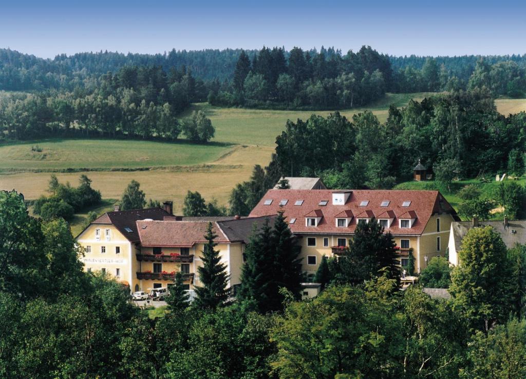 a group of buildings on a hill with trees at Waldviertler-Hof in Langschlag