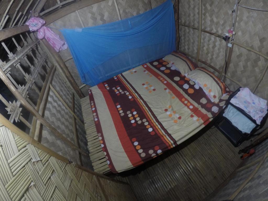 an overhead view of a bed in a room at Seafront Cottage Ocam Ocam Beach in Busuanga
