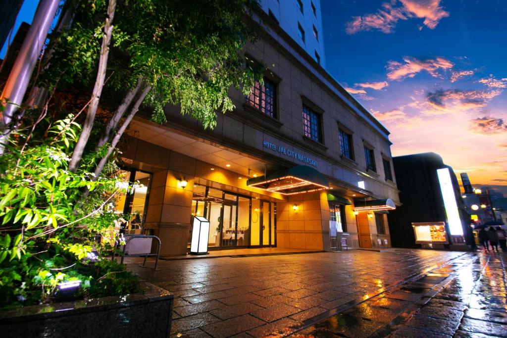 a building on a city street at night at Hotel JAL City Nagasaki in Nagasaki