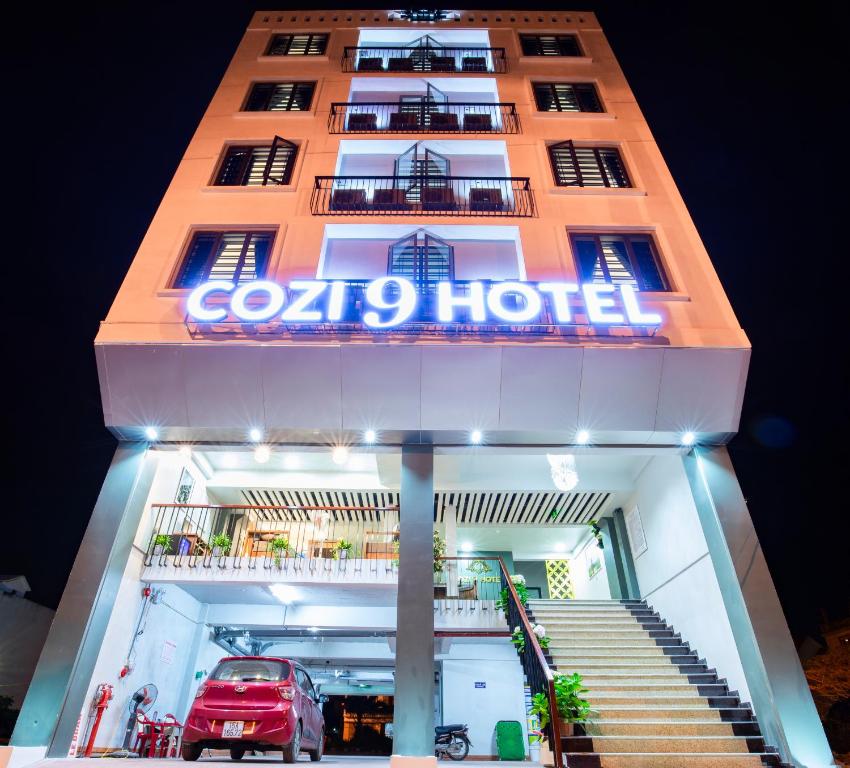 a hotel with a car parked in front of it at Cozi 9 Hotel in Hai Phong