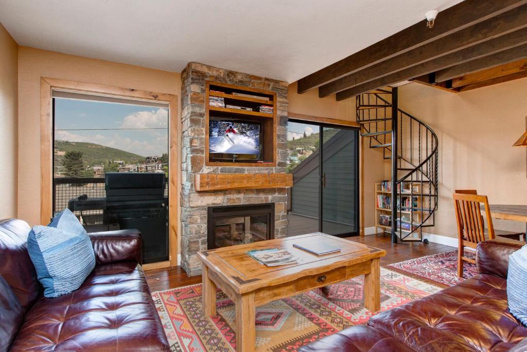 a living room with a couch and a fireplace at Quitting Time Condo in Park City