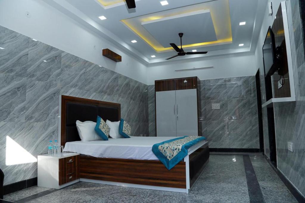 a bedroom with a bed in a room at Hotel Amar Leela in Dehradun