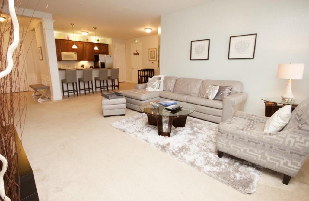 a living room with a couch and a table at Shoreway Condo #231521 in Orlando